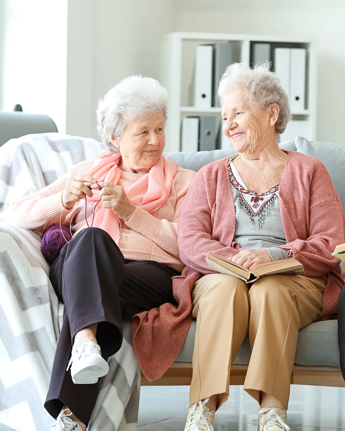 two-elder-women-reading-on-couch
