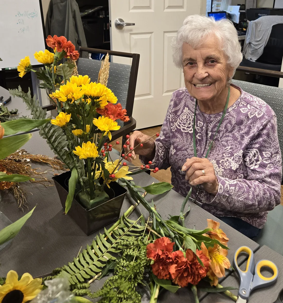 Resident-Flower-Arranging-Class Resident arranges flowers in a container